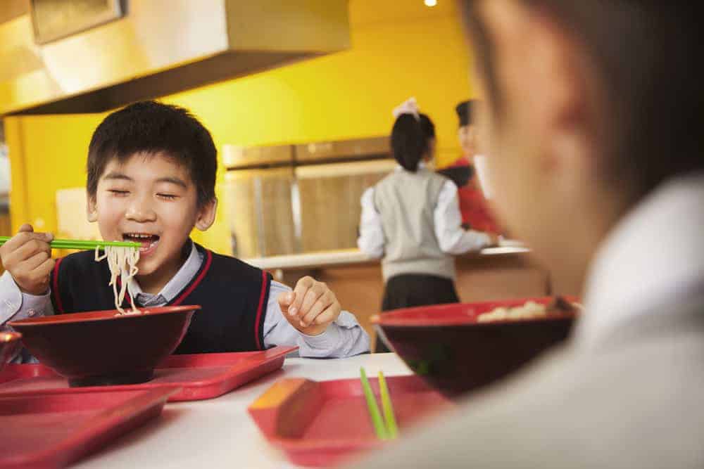 child eating noodles
