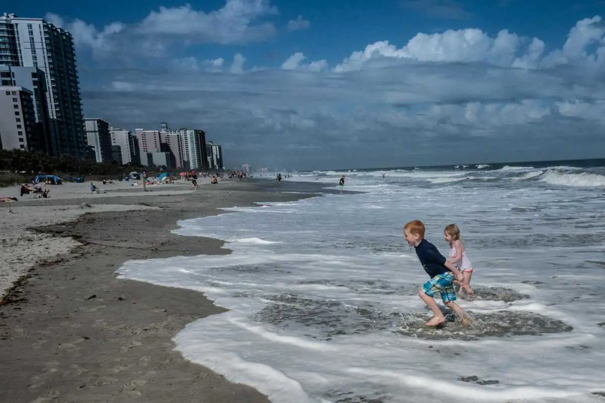 Myrtle Beach South Carolina beach with two children in the waves