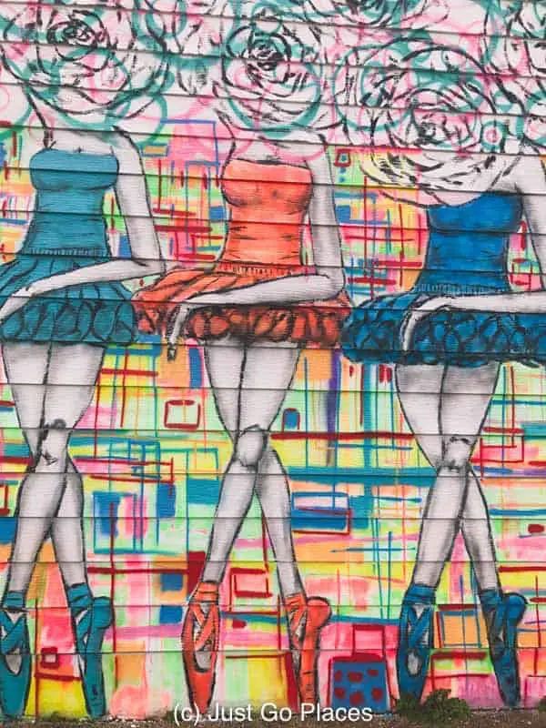 Flower-headed ballerinas, street art mural on a building in downtown Houston