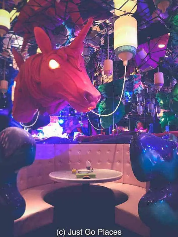 A bottle fed baby unicorn with glowing eyes at the Kawaii Monster cafe in Harajuku