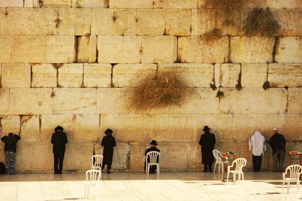 Praying at the Western Wall, one of the holy places in Jerusalem which is THE holy city of Judaism. 