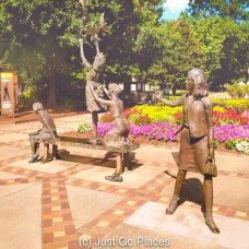 A statue to the four girls killed in the 16th Street Baptist Church Birmingham bombing at the corner of Kelly Ingram Park facing onto the church itself.