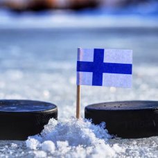 Finland Flag on a toothpick between two hockey pucks