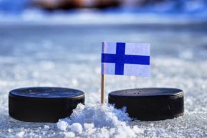 Finland Flag on a toothpick between two hockey pucks