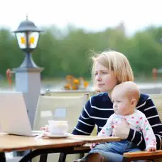 mother with baby working on computer