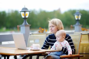 mother with baby working on computer