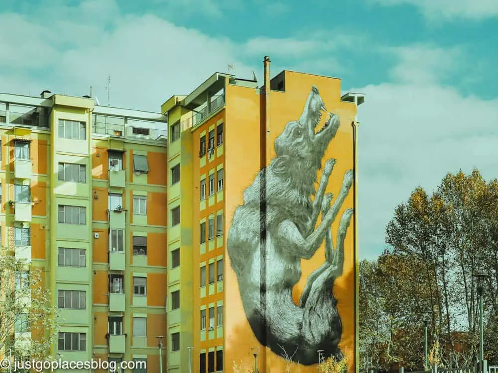 street art of the Roman wolf on the side of an apartment block