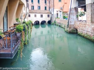 Things to do in Treviso include sitting in a Treviso restaurant on a canal