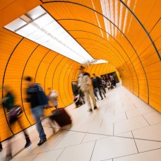 People rushing through a subway corridor