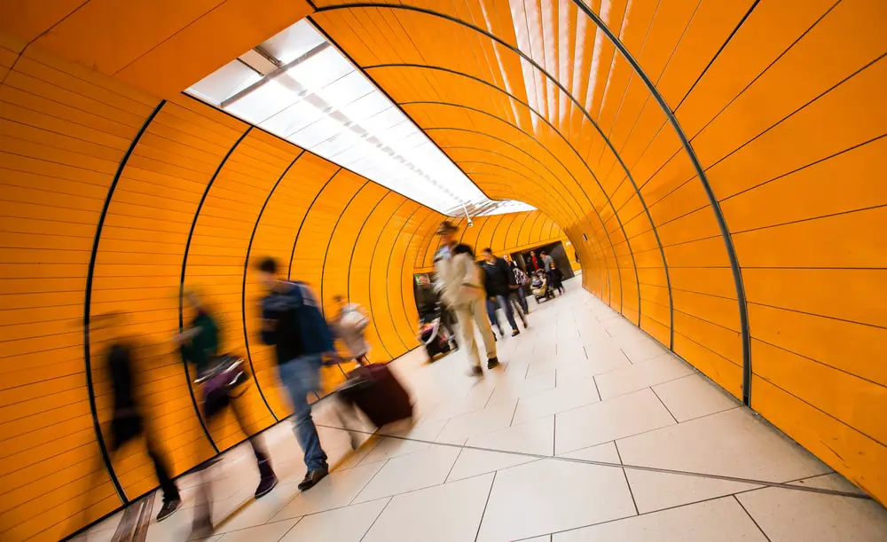 People rushing through a subway corridor