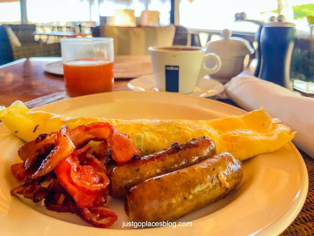breakfast of bacon sausages and omelette and juice at East Winds Resort St Lucia