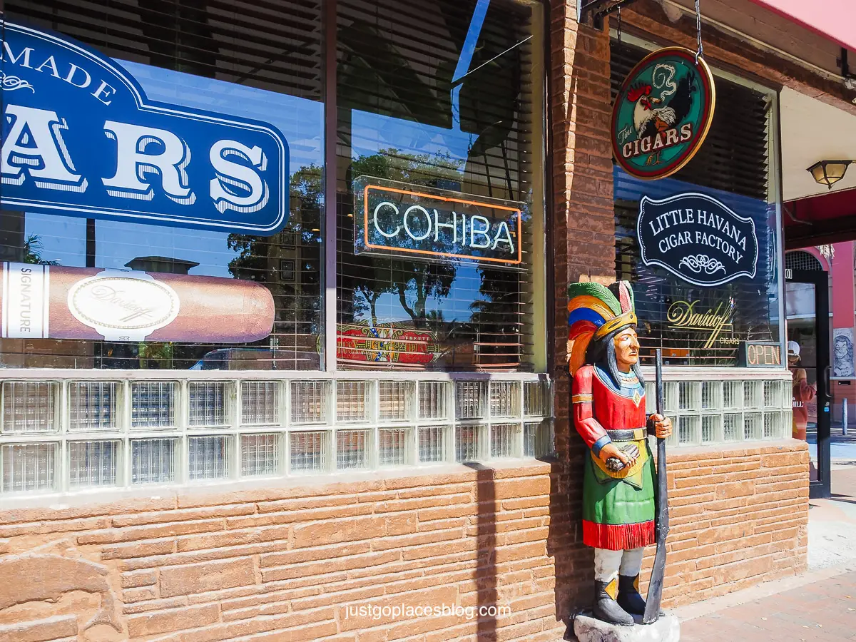 A cigar store Indian in front of a Cigar Store