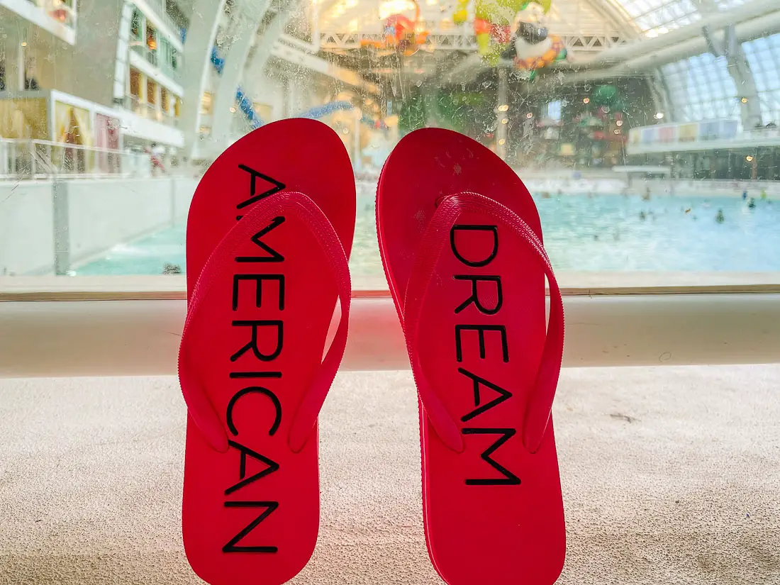 American Dream flip flops in front of the American Dream Pool