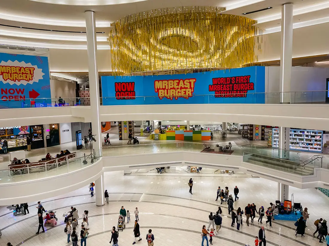 view of the first floor of American Dream Mall with people and kids on Dream Riders mechanical animals